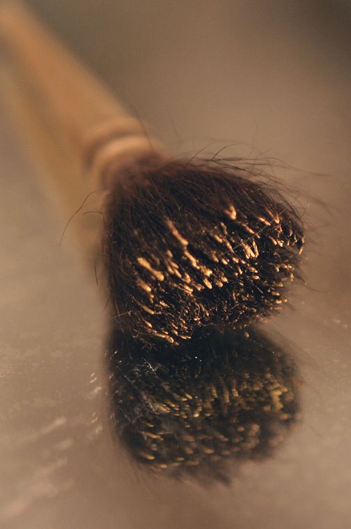 Détail photographique d'un pinceau de doreur à la feuille.