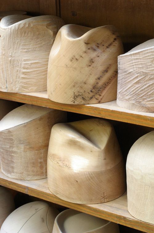 Photographie de modèles de formes en bois de chapeaux.